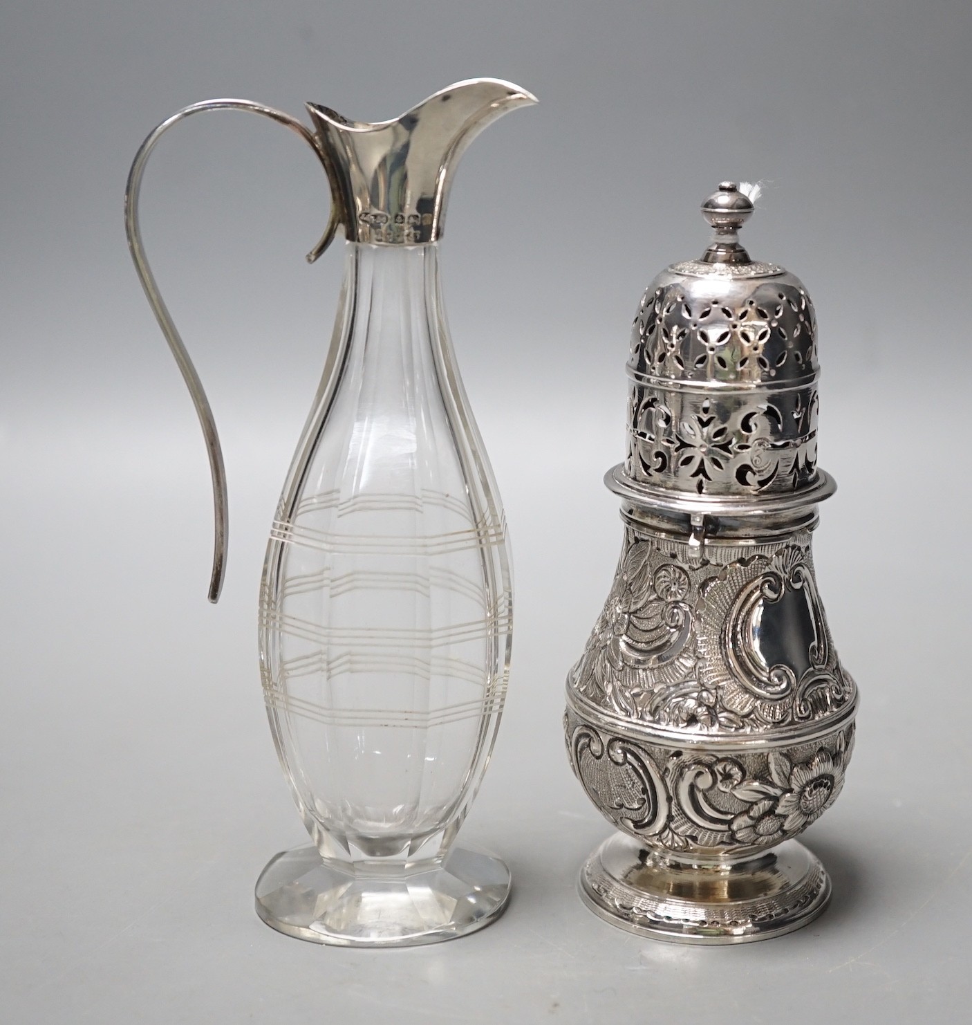 A late Victorian silver helmet shaped cream jug, a silver sugar bowl, a silver mustard pot, a silver mounted posy vase and a silver two handled bowl.